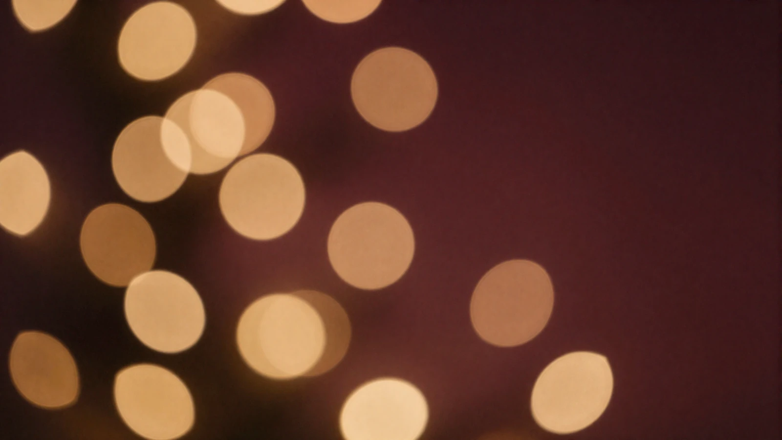 Warm golden and burgundy bokeh lights evoking a romantic evening atmosphere for Amorpulse